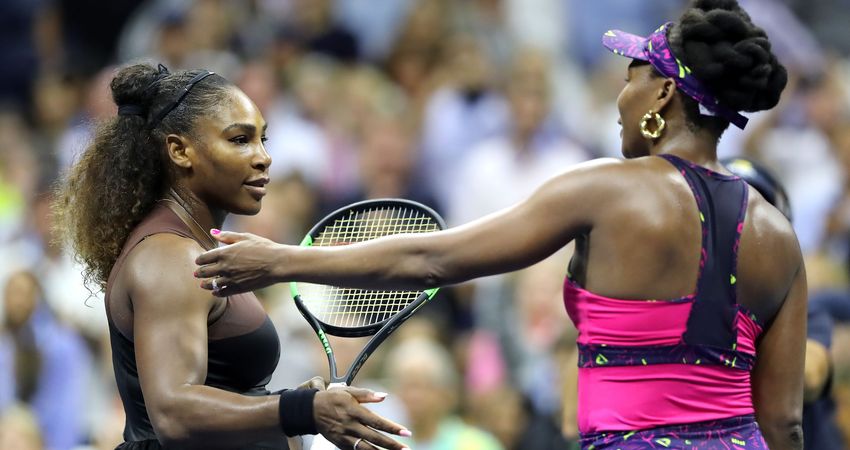 The sisters hug after their third-round clash (Getty)