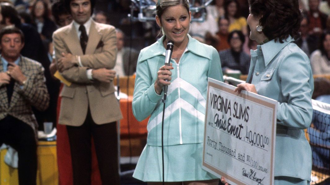 Chris Evert receives a check during the trophy presentation for the Virginia Slims Championships after defeating Martina Navratilova at Los Angeles Memorial Sports Arena.