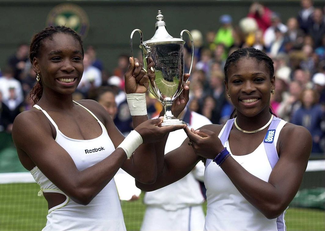 Venus and Serena Williams beat Julie Halard-Decugis and Ai Sugiyama in the final to become the first sisters ever to win Wimbledon.