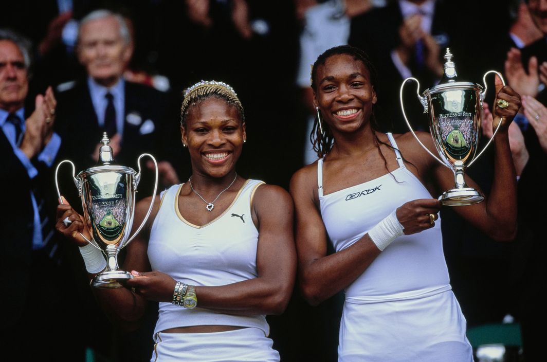 Serena and Venus Williams beat Virginia Ruano Pascual and Paola Suarez 6-2, 7-5 to win their second Wimbledon title.