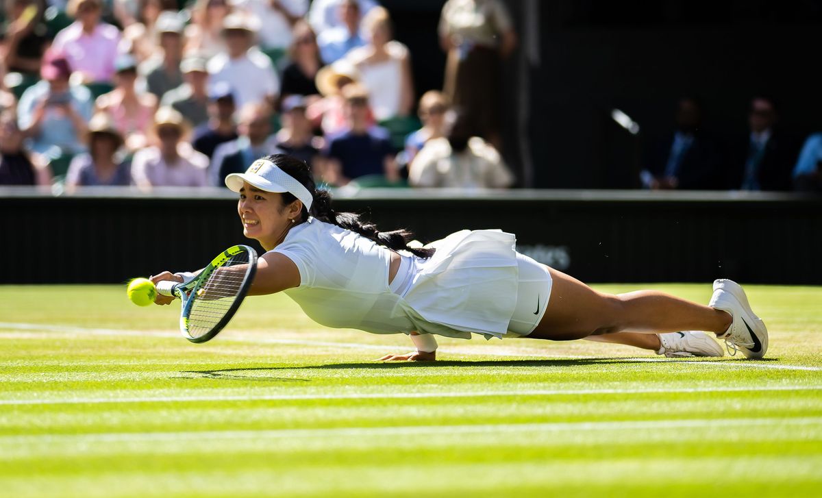 Alexandra Eala stretches for a ball after slipping on Centre Court