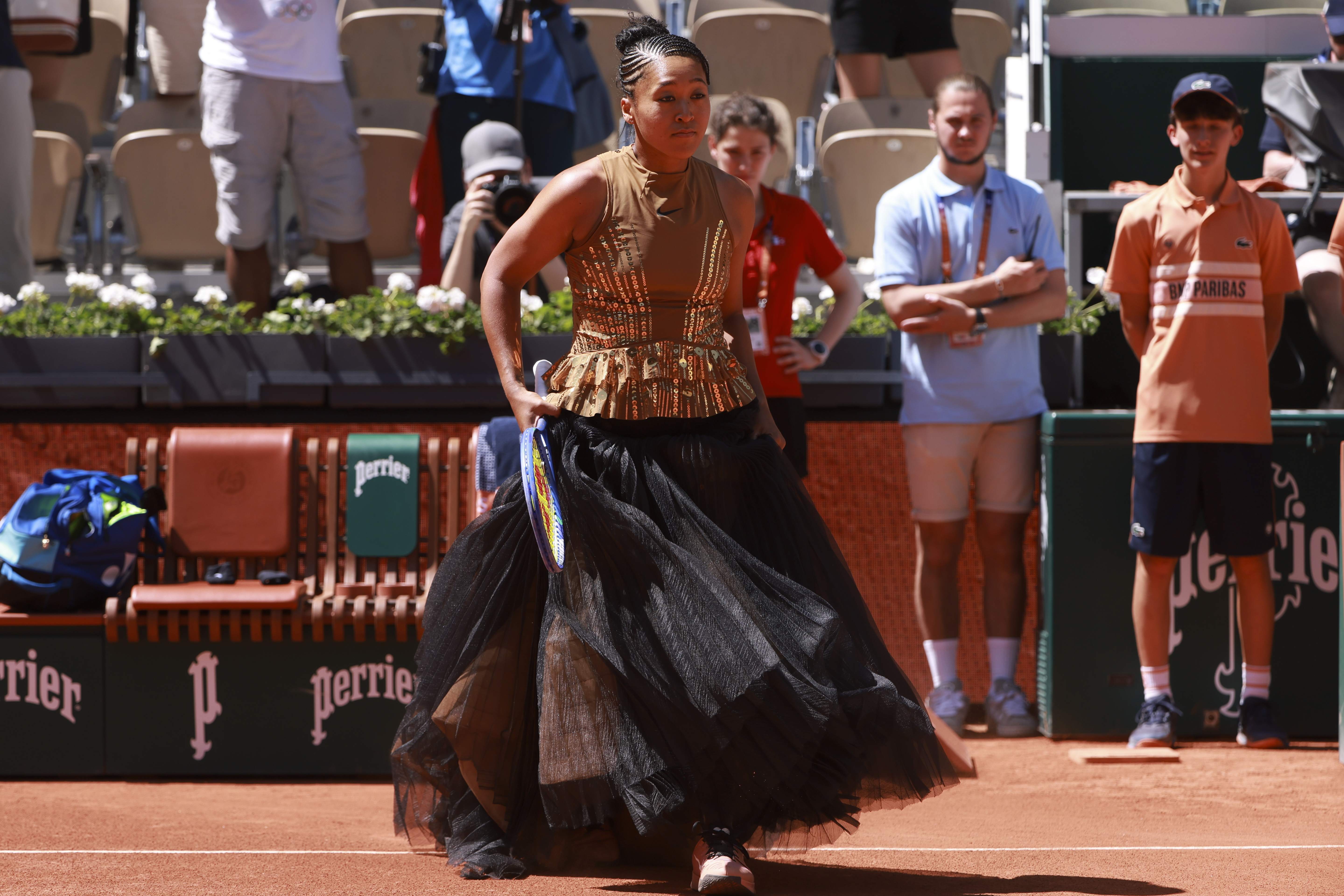 Osaka turns heads with black corset and gold dress at Roland Garros