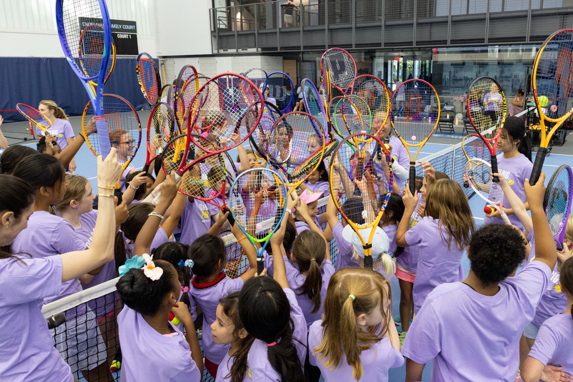 Young girls participating in the Dream Big. Play Big. tennis clinic at Riverside Tennis.